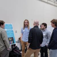 a group of people around a senior project